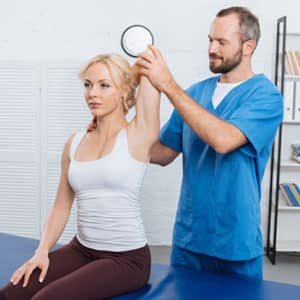 Riverview Chiropractor Guiding a Brandon Lady on Physiotherapy Exercises