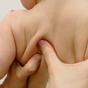 Brandon Pediatric Chiropractor Massaging Back if Riverview Baby