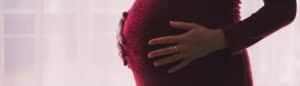 Riverview Woman Holding Stomach After Visiting Brandon Pregnancy Chiropractor Clinic