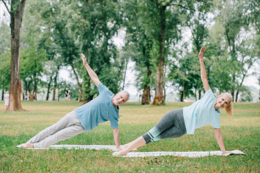 Middle-aged Couple Recovering From Disc Injuries with Help of Chiropractor Exercising in a Park in Riverview FL