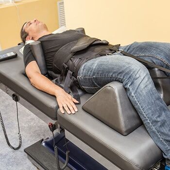 Brandon Man Lying on Chiropractic Table in Riverview for Spinal Decompression Treatment